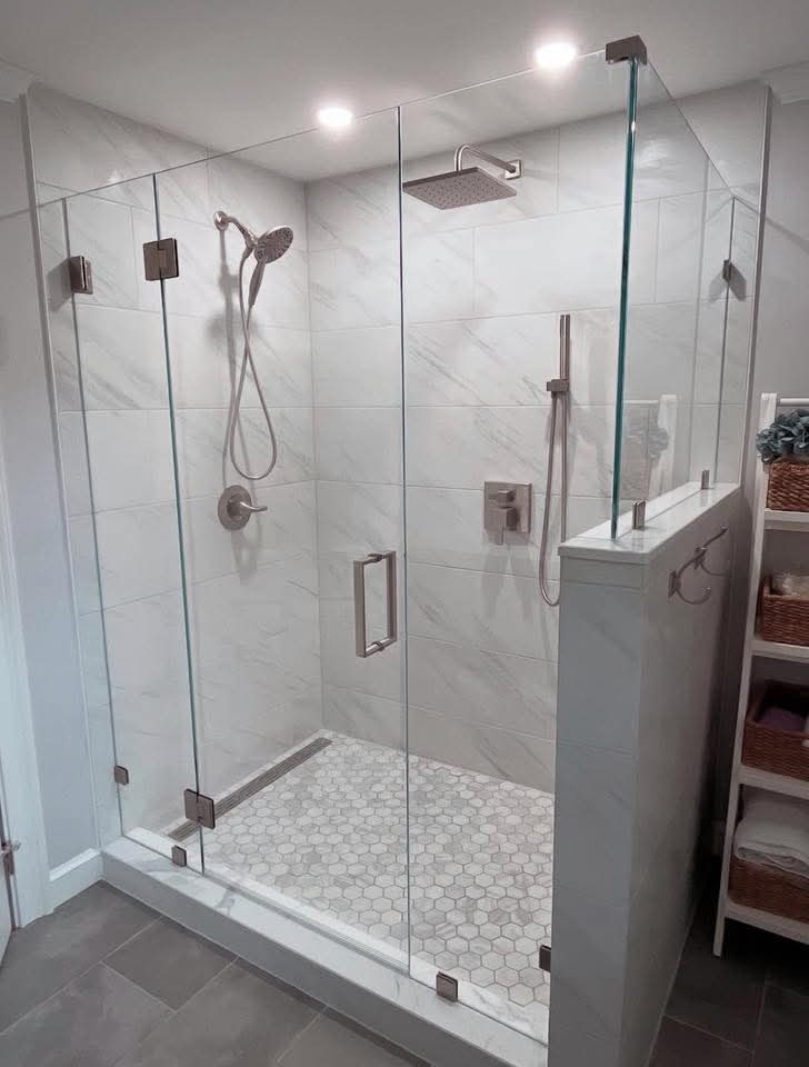 Newly installed frameless shower door with clear glass