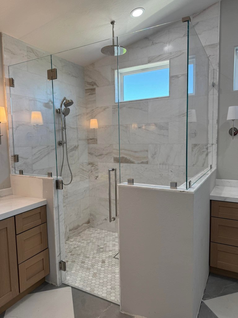 Close-up of frameless shower glass and hardware in Milpitas