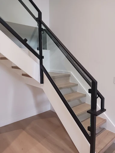 Tempered glass stair railing with metal posts in Cupertino